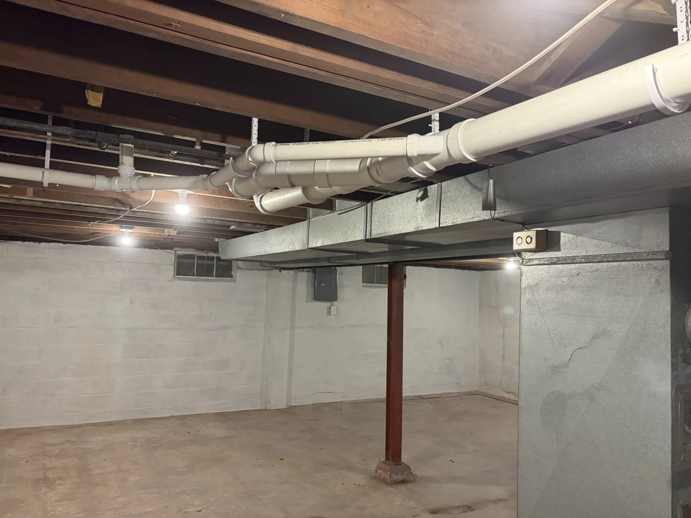 Plumbing installed along an exposed basement ceiling